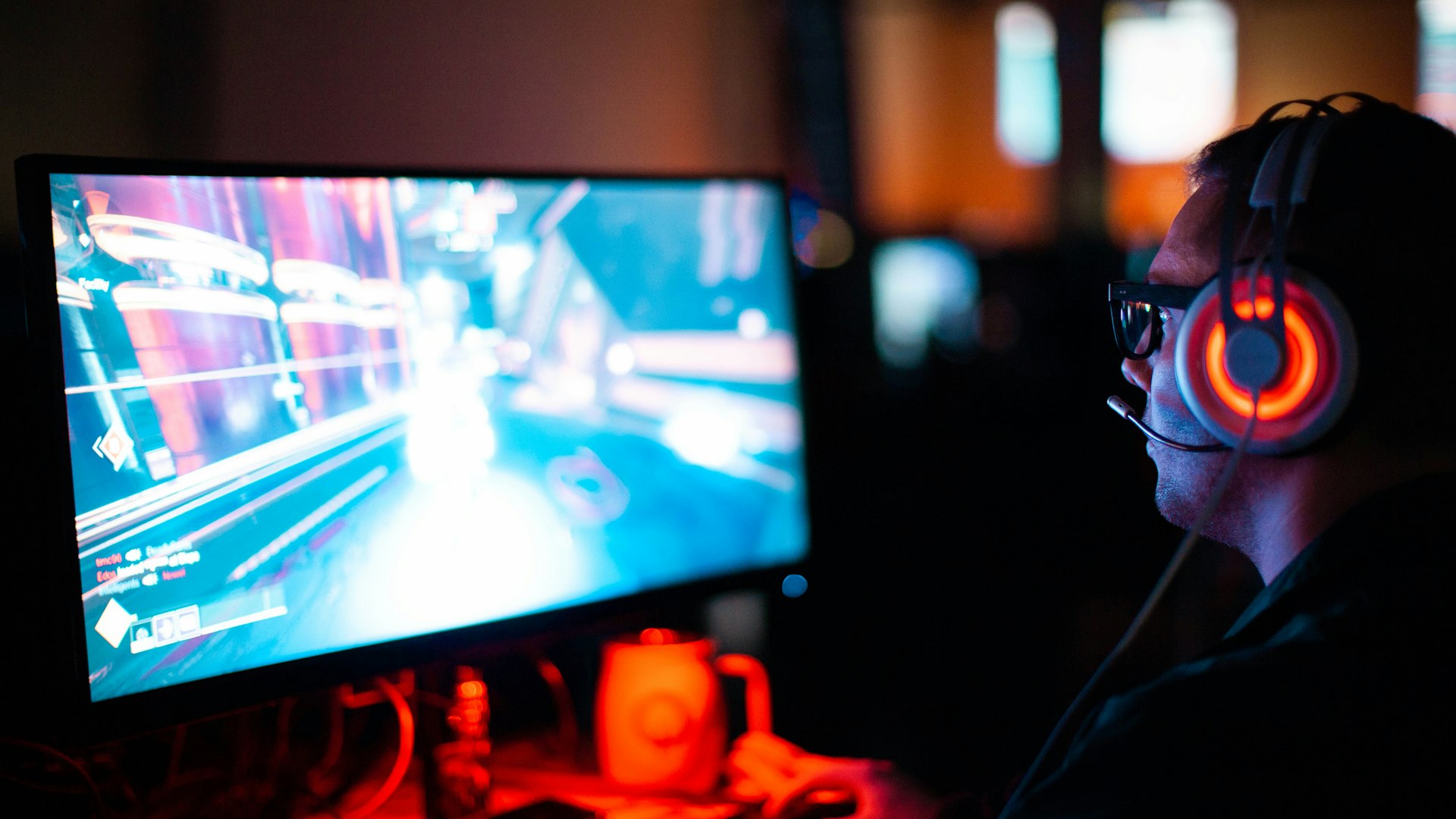 Neon-lit co-op gaming lounge with players at battle stations